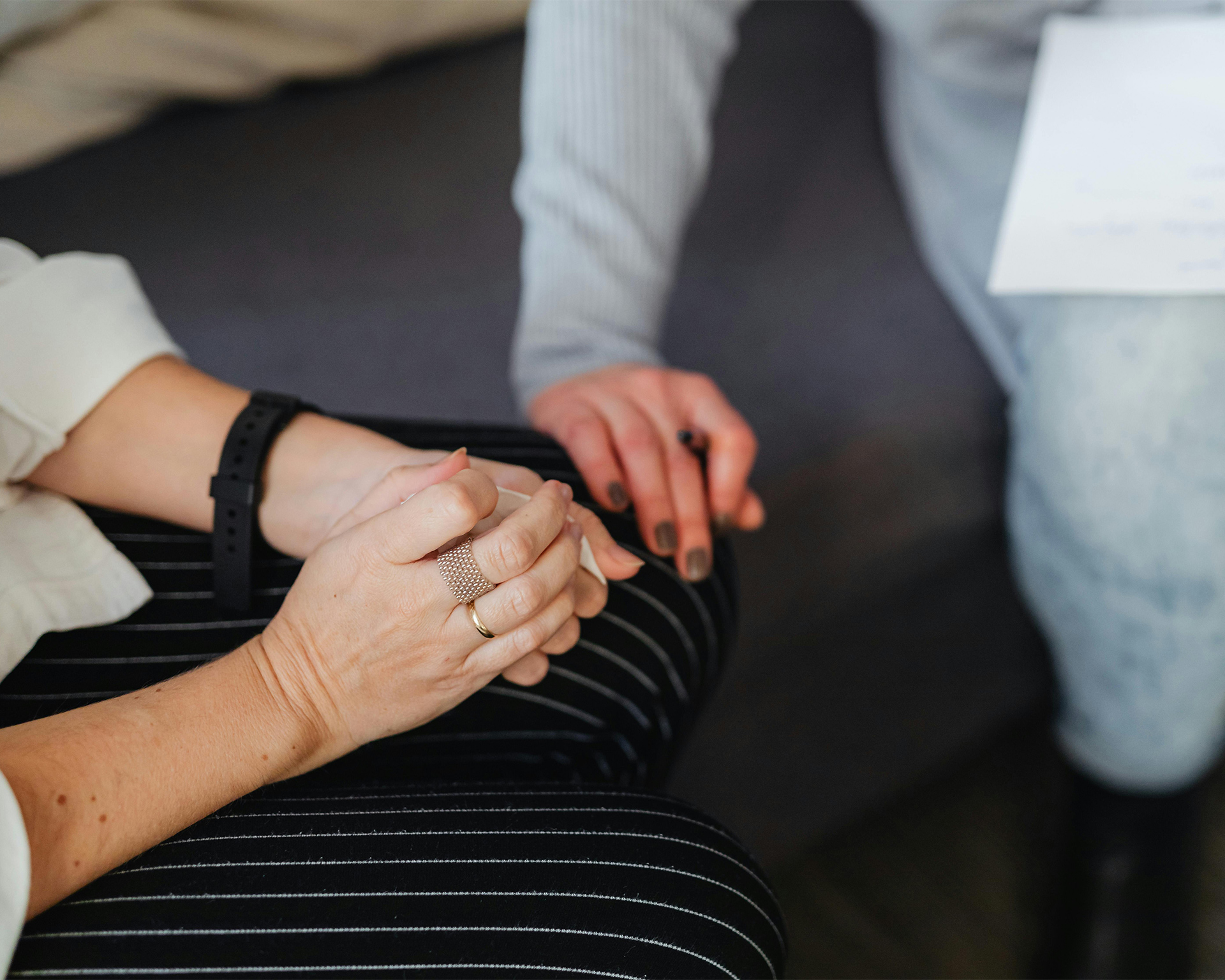 Counselling with hand on knee in offer of support
