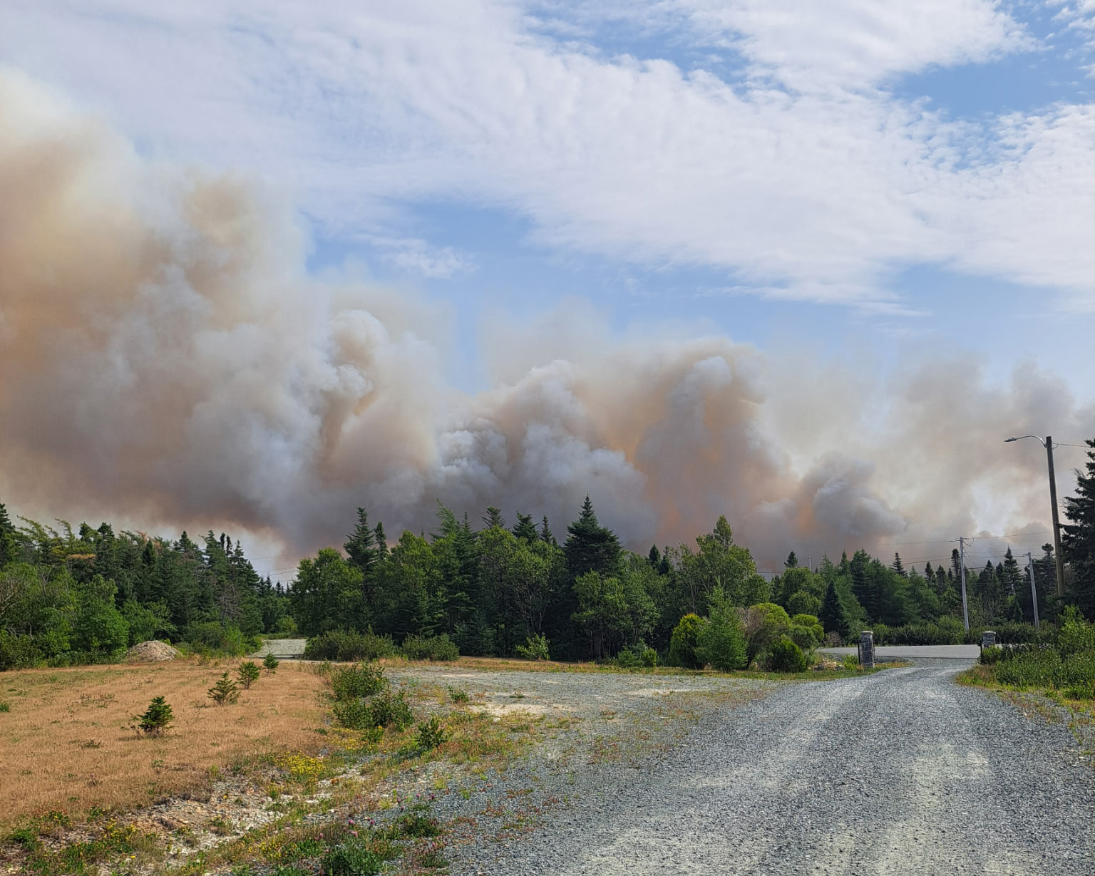 Smoke billowing ahead on a road