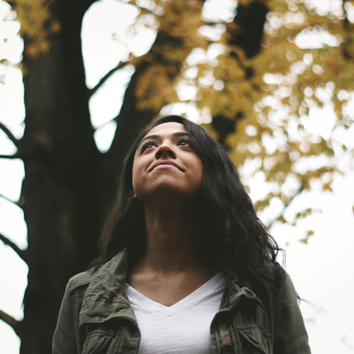 Women looking up with forest in background