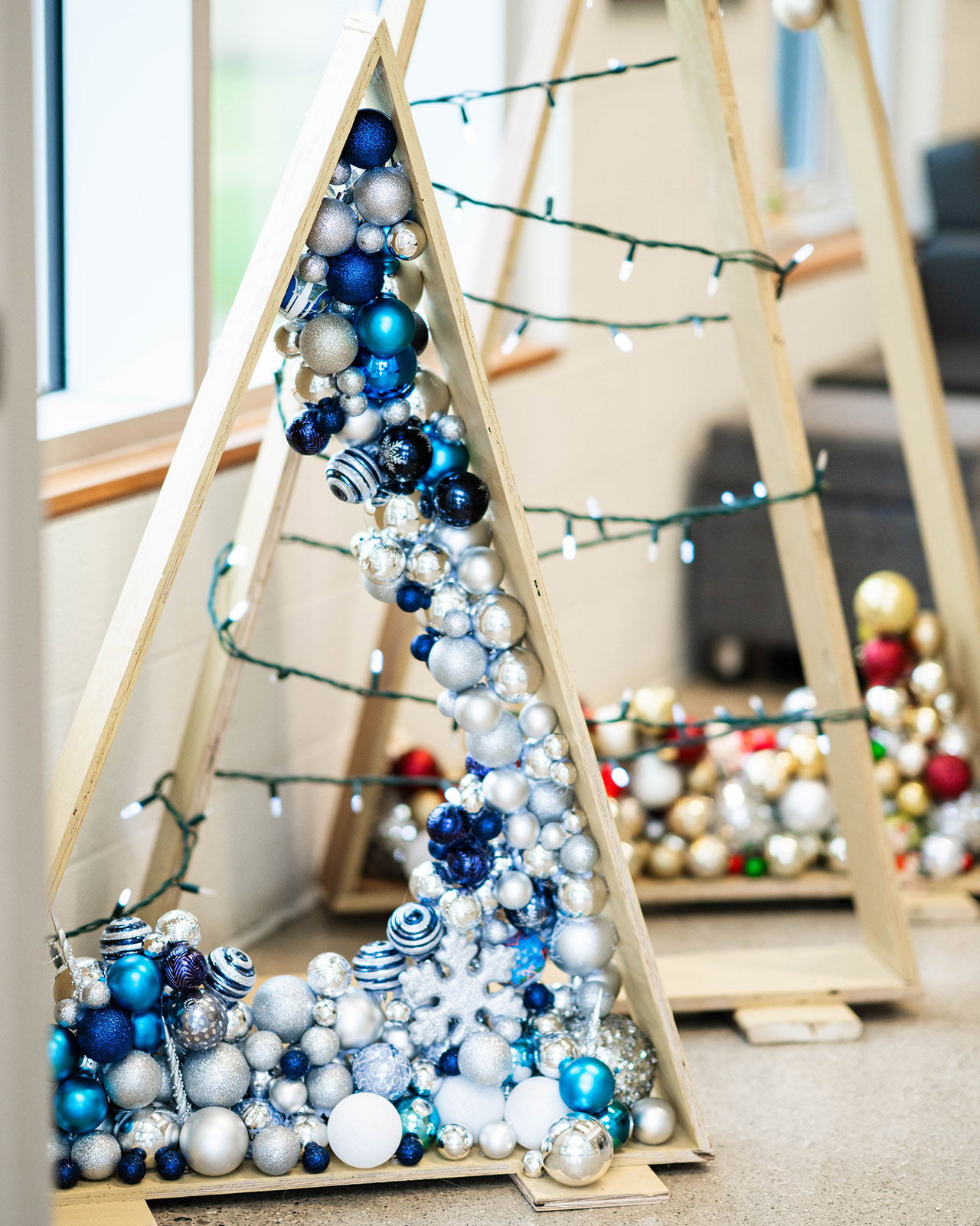 Wooden christmas tree triangles with ornaments inside