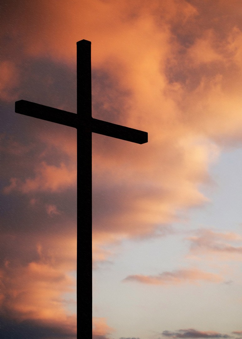 Cross against a sunset sky