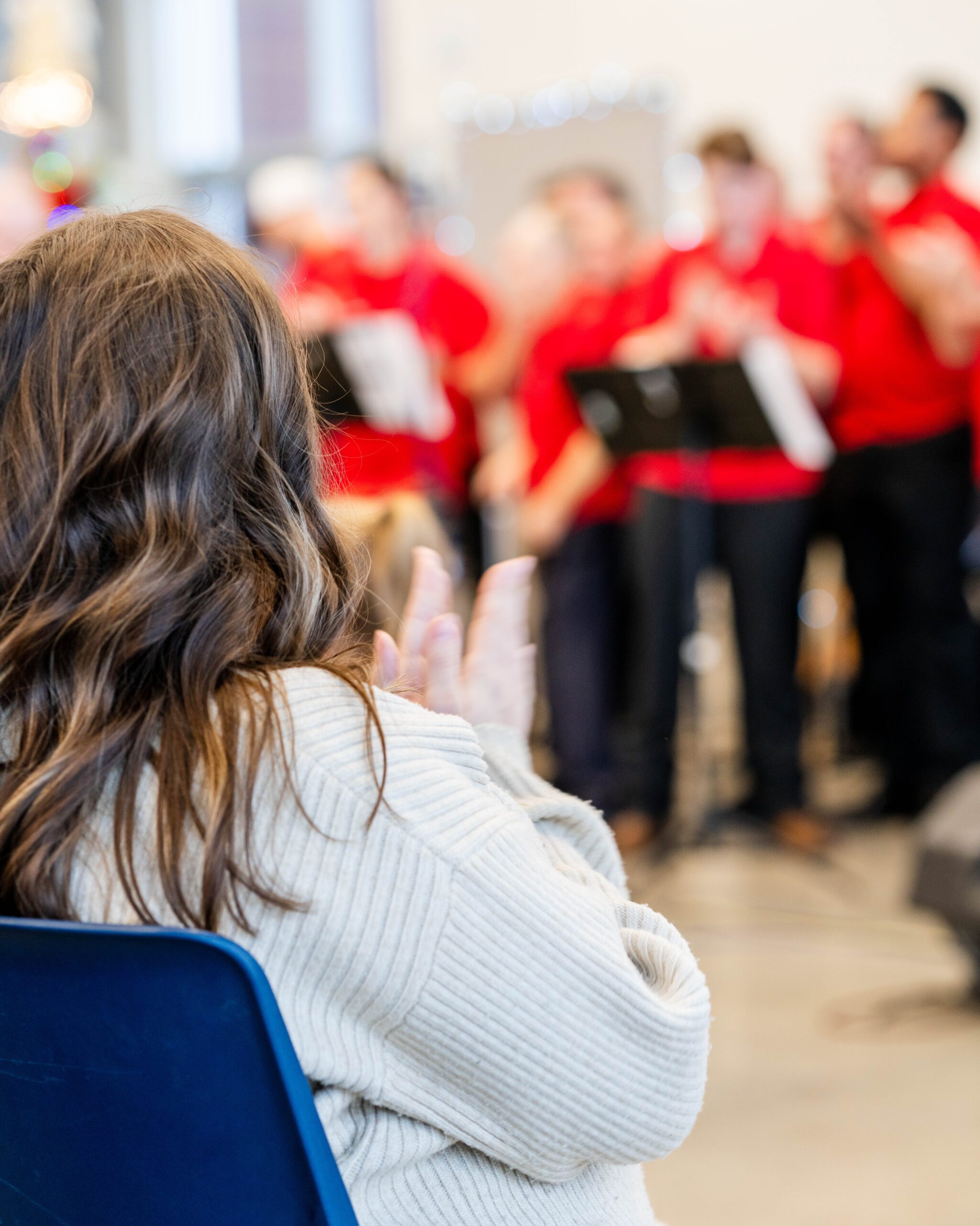 Woman watching choir sing
