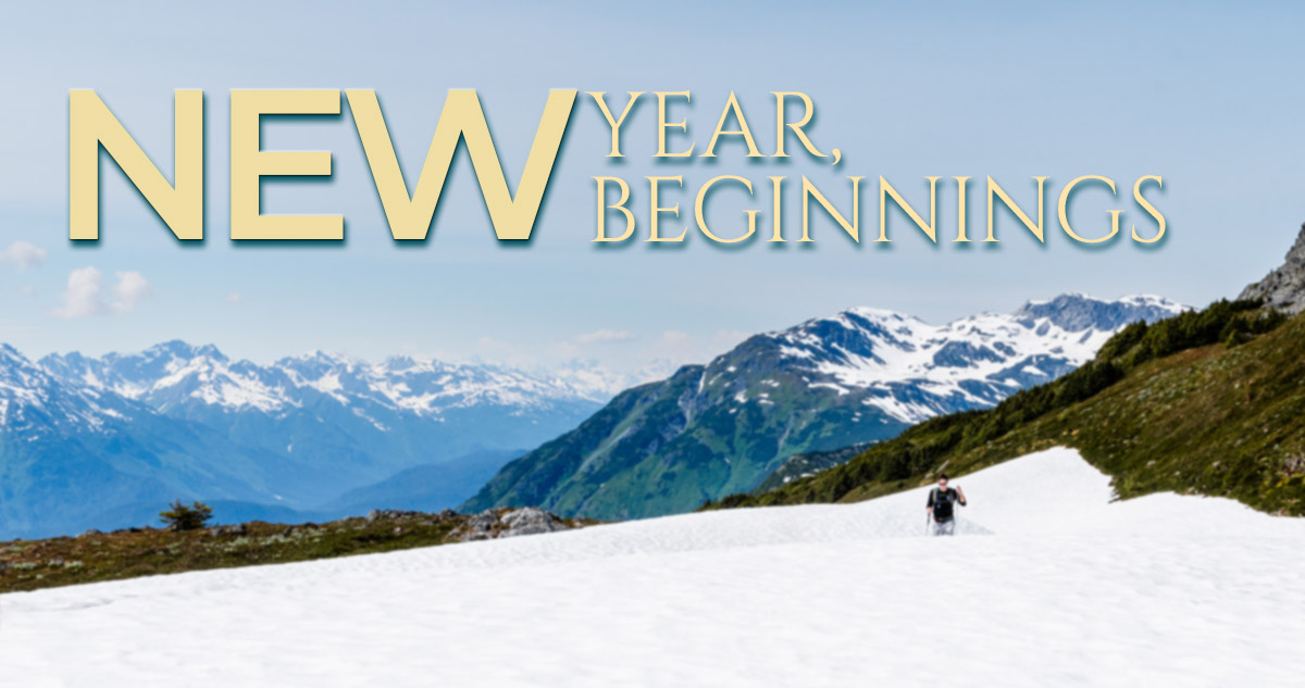 New Year, New Beginnings, solitary person walking on snowy mountain