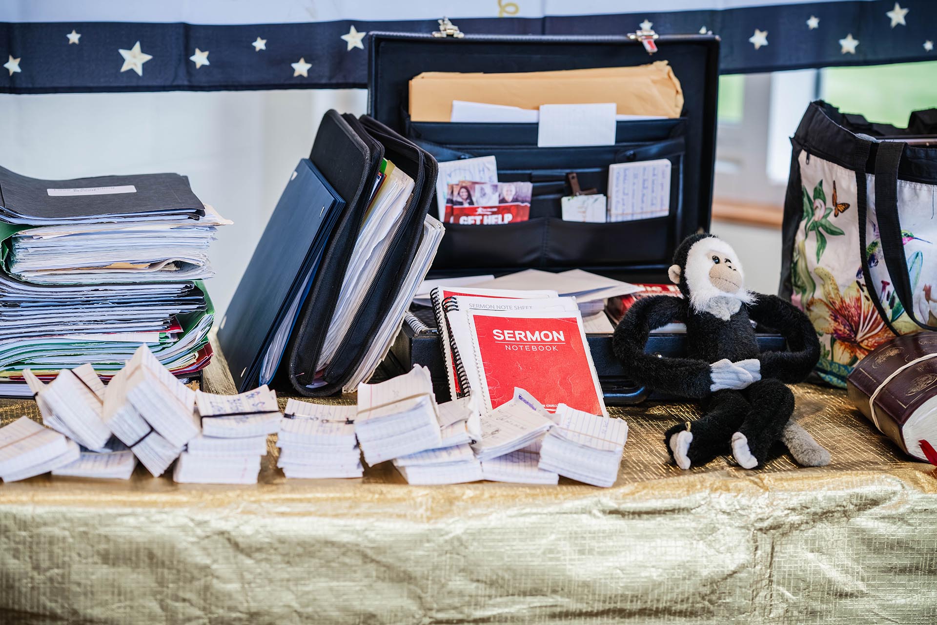 Table filled with sermon notes, verses, notebooks