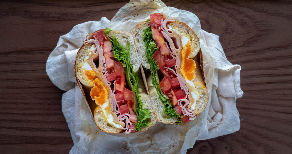 sandwich in wrapper, split in half