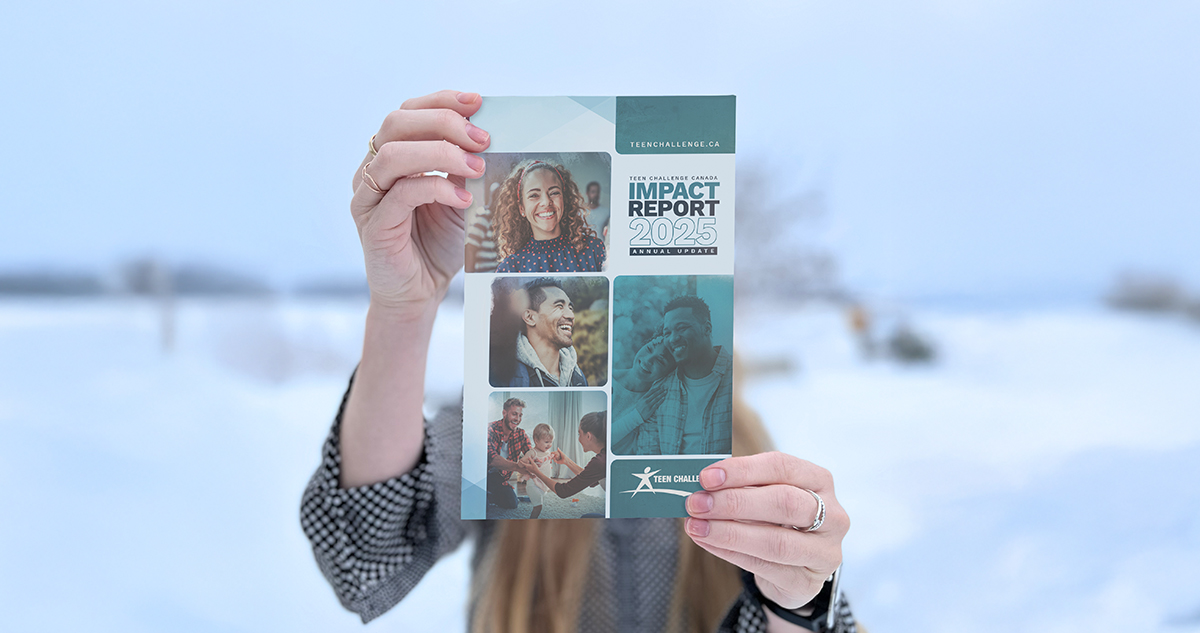 Impact Report being held out in front